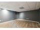 Basement area with neutral carpet and light gray walls, offering a versatile space at 14 Augusta Way, Hiram, GA 30141