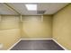 Unfinished basement with gray floor, drop ceiling and yellow painted walls at 14 Augusta Way, Hiram, GA 30141