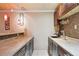 Basement bar features sink, countertop, cabinets and decorative backsplash at 14 Augusta Way, Hiram, GA 30141
