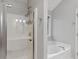 Bathroom featuring a sleek glass shower and soaking tub with neutral wall color at 14 Augusta Way, Hiram, GA 30141
