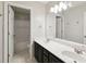 Bright bathroom featuring a double sink vanity, large mirror, and a combined shower and tub at 14 Augusta Way, Hiram, GA 30141