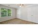 Bright bedroom features a ceiling fan, window with natural light, and large closets at 14 Augusta Way, Hiram, GA 30141