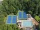 Aerial view of community amenities including tennis courts, pool, and recreation area, all surrounded by mature trees at 14 Augusta Way, Hiram, GA 30141