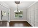 Elegant dining room with hardwood floors, white columns, and a chandelier, creating a sophisticated space at 14 Augusta Way, Hiram, GA 30141