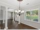 Elegant dining room with hardwood floors, white columns, and a chandelier, creating a sophisticated space at 14 Augusta Way, Hiram, GA 30141