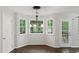 Dining room with large windows and a modern chandelier at 14 Augusta Way, Hiram, GA 30141