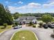 Lovely clubhouse exterior with well-manicured landscaping, parking, and green surroundings at 14 Augusta Way, Hiram, GA 30141