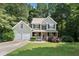 Charming two-story home with a well-manicured lawn, two-car garage, and a welcoming front porch at 14 Augusta Way, Hiram, GA 30141