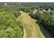 Aerial view of a lush golf course surrounded by trees and greenery at 14 Augusta Way, Hiram, GA 30141