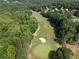 Aerial view of a lush green golf course surrounded by trees and residential homes at 14 Augusta Way, Hiram, GA 30141