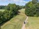 Scenic view of the golf course with a winding path, lush green fairways, and mature trees at 14 Augusta Way, Hiram, GA 30141