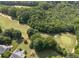 Overhead shot of neighborhood featuring a golf course, surrounded by lush trees and homes at 14 Augusta Way, Hiram, GA 30141