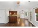 Open-plan living room with hardwood floors and access to the kitchen and outdoors at 14 Augusta Way, Hiram, GA 30141