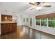 Open-concept living room features wood bar, stainless appliances, hardwood floors, and wooded backyard view at 14 Augusta Way, Hiram, GA 30141