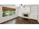 Living room with hardwood floors, fireplace and custom built-in shelving at 14 Augusta Way, Hiram, GA 30141