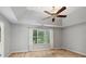 Spacious bedroom with tray ceiling, fan, and large window offers a tranquil and inviting atmosphere at 14 Augusta Way, Hiram, GA 30141