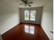 Bright bedroom with gleaming hardwood floors and a large window for ample natural light at 2994 Abbotts Oak Way, Duluth, GA 30097