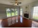 Cozy living room featuring hardwood floors, a fireplace, and lots of natural light at 2994 Abbotts Oak Way, Duluth, GA 30097