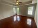 Primary bedroom featuring hardwood floors, trey ceilings, and multiple windows at 2994 Abbotts Oak Way, Duluth, GA 30097