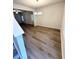Dining room with wood-look flooring, chandelier, and views into the adjacent room at 836 Courthouse Park Dr, Temple, GA 30179