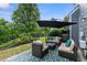 Backyard patio with shaded seating and a view of lush greenery at 110 Finchley Dr, Roswell, GA 30076