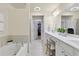 Spacious bathroom with double vanity, soaking tub, and a walk-in closet at 110 Finchley Dr, Roswell, GA 30076