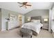 Bright bedroom featuring a tufted headboard, soft lighting, and a serene atmosphere at 110 Finchley Dr, Roswell, GA 30076