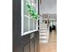 Inviting entryway with hardwood floors, a staircase and view into the living area at 110 Finchley Dr, Roswell, GA 30076