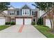 Charming townhome with a two-car garage, brick accents and well-maintained landscaping at 110 Finchley Dr, Roswell, GA 30076