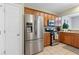 Well-lit kitchen featuring stainless steel appliances and beautiful wooden cabinets at 110 Finchley Dr, Roswell, GA 30076