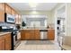 Well-equipped kitchen featuring stainless steel appliances and views into the living area at 110 Finchley Dr, Roswell, GA 30076