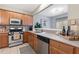 Updated kitchen with stainless steel appliances and a view to the living room at 110 Finchley Dr, Roswell, GA 30076