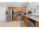 Spacious kitchen featuring stainless steel appliances, tile floors, and ample counter space at 110 Finchley Dr, Roswell, GA 30076