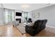 Cozy living room with a fireplace, hardwood floors, and large windows with natural light at 110 Finchley Dr, Roswell, GA 30076