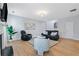 Bright living room with hardwood floors, a fireplace, and comfortable seating arrangement at 110 Finchley Dr, Roswell, GA 30076