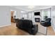 Comfortable living room featuring hardwood floors, a fireplace, and access to the kitchen at 110 Finchley Dr, Roswell, GA 30076