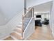 Elegant staircase with wood treads, white risers, decorative black iron balusters, and hardwood floors at 110 Finchley Dr, Roswell, GA 30076