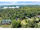 An elevated view displays this home surrounded by lush landscape near a lake at 2751 Pilgrim Mill Rd, Cumming, GA 30041