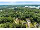 An elevated view displays this home surrounded by lush landscape near a lake at 2751 Pilgrim Mill Rd, Cumming, GA 30041