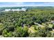 An elevated view displays this home surrounded by lush landscape near a lake at 2751 Pilgrim Mill Rd, Cumming, GA 30041
