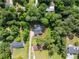 An aerial view shows the home nestled among trees on a spacious lot at 2751 Pilgrim Mill Rd, Cumming, GA 30041