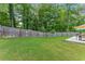 Spacious backyard has a well-maintained lawn, patio, and privacy fence at 2751 Pilgrim Mill Rd, Cumming, GA 30041