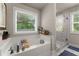 This bathroom features a large soaking tub beneath a window and a glass shower enclosure at 2751 Pilgrim Mill Rd, Cumming, GA 30041