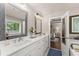 Elegant bathroom boasts double vanity, decorative mirrors and bath, connected to the main bedroom at 2751 Pilgrim Mill Rd, Cumming, GA 30041