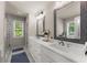 Modern bathroom featuring dual vanities, large mirrors, and a glass-enclosed shower at 2751 Pilgrim Mill Rd, Cumming, GA 30041