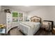 Bright bedroom featuring a plush bed, window view, and stylish decor at 2751 Pilgrim Mill Rd, Cumming, GA 30041
