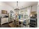 Bright dining room with a modern chandelier, large window, and coastal decor accents at 2751 Pilgrim Mill Rd, Cumming, GA 30041