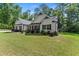 Beautifully landscaped home with an inviting front porch and manicured lawn at 2751 Pilgrim Mill Rd, Cumming, GA 30041