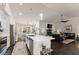 Open kitchen with island seating, stainless appliances and view of dining and living spaces at 2751 Pilgrim Mill Rd, Cumming, GA 30041