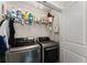 Functional laundry room with modern washer and dryer, shelving, and storage space at 2751 Pilgrim Mill Rd, Cumming, GA 30041